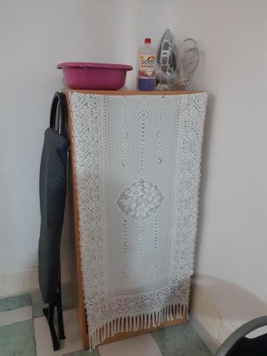 a cabinet with a white lace curtain and a knife at Just for me in Lima