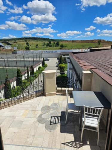 a patio with a table and chairs on a roof at Castello in Baile Felix