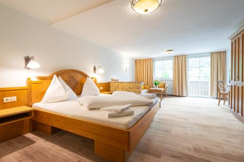 a bedroom with a large bed in a room at Landhotel Hubengut Bed and Breakfast in Radstadt