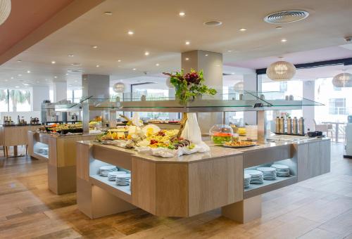 a buffet in a restaurant with a lot of food at Marins Playa in Cala Millor