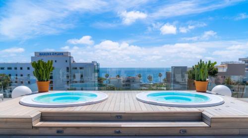 two hot tubs on the roof of a building at Marins Playa in Cala Millor