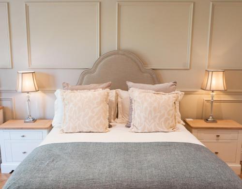 a bedroom with a bed with pillows and two lamps at The Spinney in Scarborough