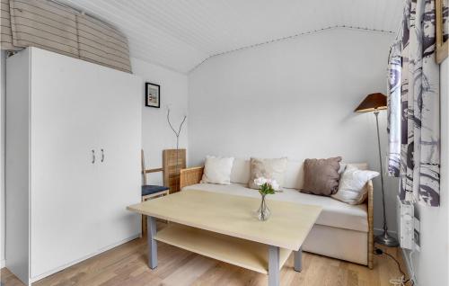 a living room with a couch and a table at Amazing Home In Dannemare With Wifi in Dannemare