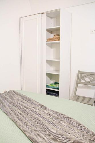 a room with a closet with a door and a rug at La Vispa Teresa Almalusa Apulian home in Martina Franca