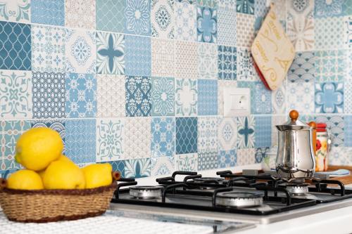 a basket of lemons sitting on a stove in a kitchen at a Procida da Antonella in Procida