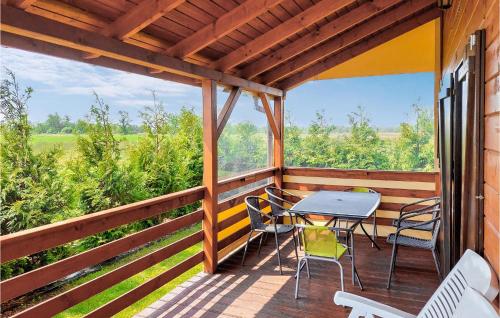 a wooden porch with a table and chairs on it at Lovely Home In Kladno With Kitchen in Pleśna