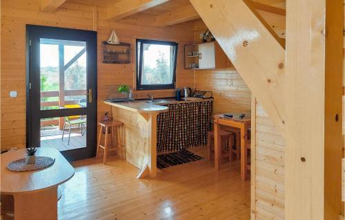 a kitchen with a counter in a wooden cabin at Lovely Home In Kladno With Kitchen in Pleśna
