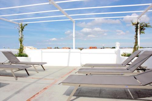 a pair of lounge chairs on a roof at Hotel Intorno Al Fico in Fiumicino