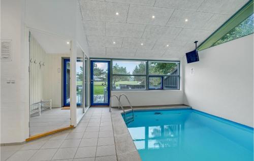 a swimming pool in the middle of a house at Cozy Home In Hjørring With Sauna in Lønstrup