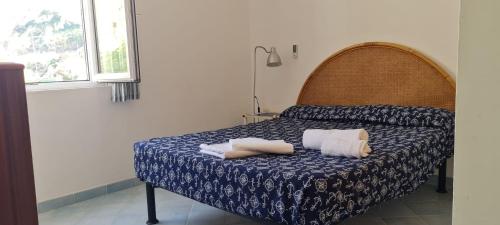 a bedroom with a bed with two towels on it at casa bisnonna pina in Ponza