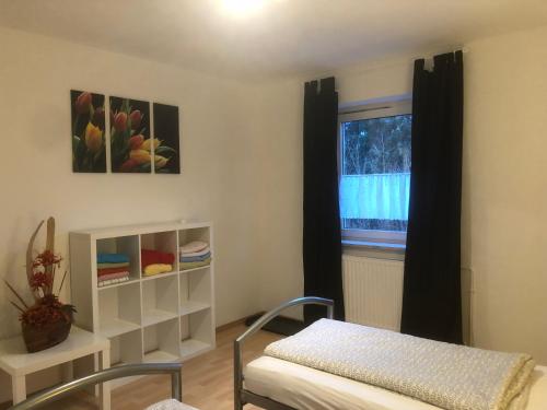 a room with a bed and a window at Monteurwohnung in Salzgitter