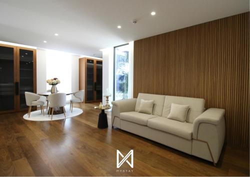 a living room with a white couch and a table at MyStay - Casa 134 in Ribeirão