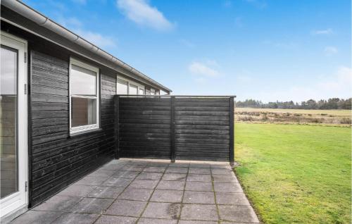 a wooden garage door on the side of a house at Cozy Home In Pandrup With Wifi in Pandrup