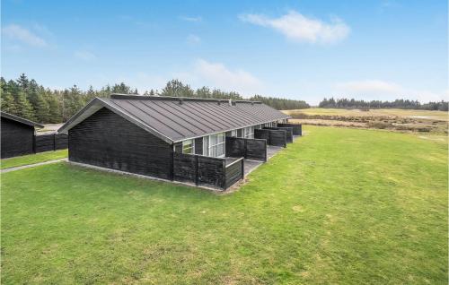 an aerial view of a black house on a grass field at Cozy Home In Pandrup With Wifi in Pandrup