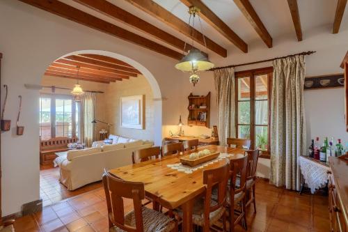 a dining room with a table and a couch at Can Pinoi by Rentallorca in Inca