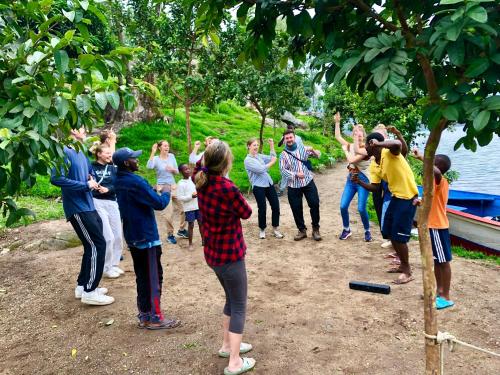a group of people standing next to a tree at Inzozi Eco Camp in Gishyita