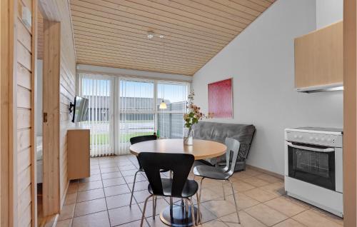 a kitchen with a table and chairs in a room at 2 Bedroom Lovely Home In Pandrup in Pandrup