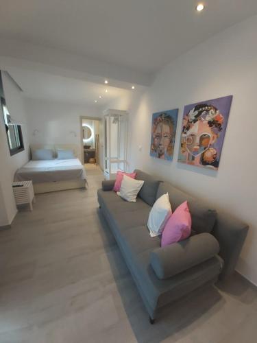 a living room with a couch and a bed at House Karga in Ormos Panagias