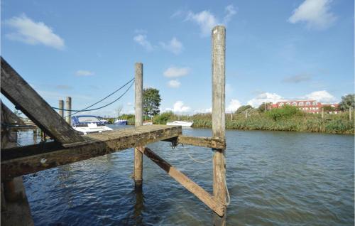 a wooden dock with a boat in the water at Holiday Home Gredstedbro 2 in Gredstedbro