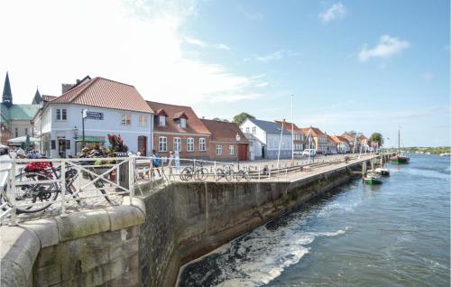 a bridge over a body of water with buildings at Holiday Home Gredstedbro 2 in Gredstedbro