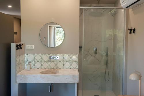 a bathroom with a sink and a shower at Casa da Corredoura Turismo Rural in Celorico de Basto