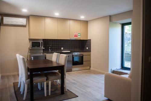a kitchen and dining room with a table and chairs at Casa da Corredoura Turismo Rural in Celorico de Basto