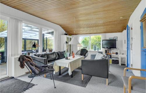 a living room with a couch and a table at Two-Bedroom Holiday Home With A Fireplace In Rømø in Bolilmark