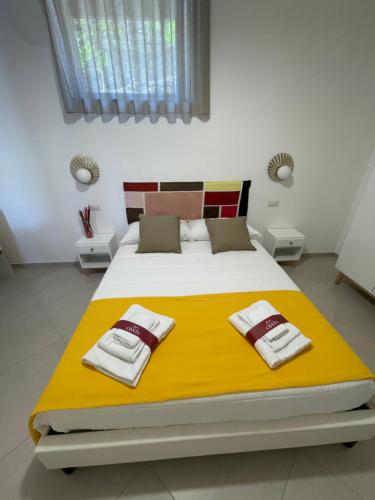 a bedroom with a large bed with towels on it at Casale Conti in Castellabate