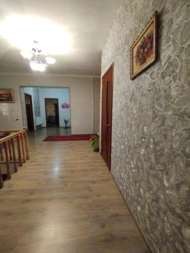 a hallway of a room with a stone wall at Эд и Эр гостевой дом ближе к аэропорту in Argavand