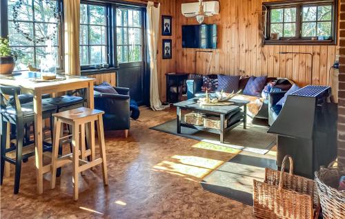 a living room with a couch and a table at Two-Bedroom Holiday Home In Almeboda in Pålsmåla