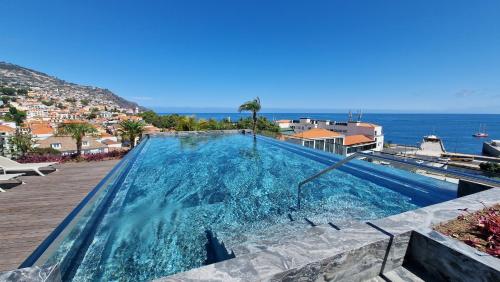 a swimming pool with a view of the ocean at Daysy Loft by LovelyStay in Funchal