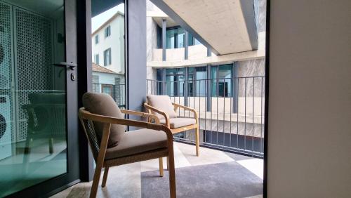 a pair of chairs sitting on a balcony at Daysy Loft by LovelyStay in Funchal