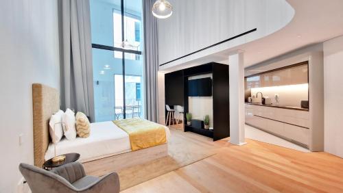 a bedroom with a king sized bed and a balcony at Daysy Loft by LovelyStay in Funchal