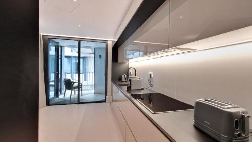 a kitchen with a sink and a window at Daysy Loft by LovelyStay in Funchal