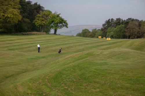 two people standing in a large grassy field at Glasgow Westerwood Hotel, Spa & Golf Resort in Cumbernauld