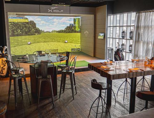 a restaurant with tables and chairs and a large window at Hilton Dubai Al Habtoor City in Dubai