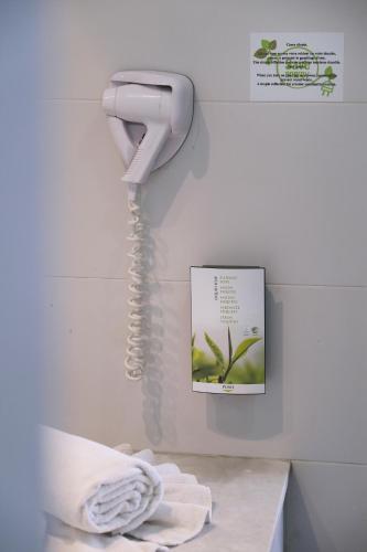 a phone hanging on a wall next to a towel at Valeria Jardins d'Agadir - All In in Agadir