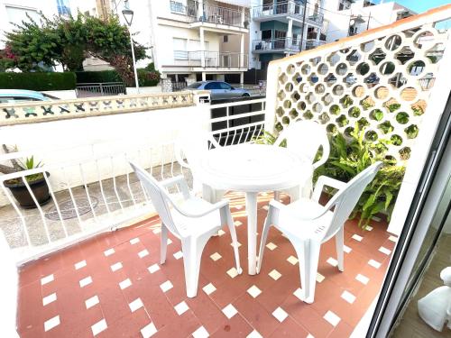 a white table and chairs on a balcony at Apartment Sanatori Beach, Barcelona in Calafell