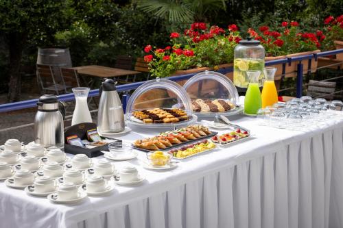 a white table with food and drinks on it at Rogner Hotel Tirana in Tirana