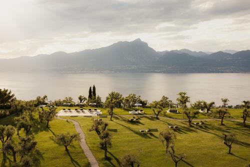 a park with a view of a lake and mountains at Cape of Senses in Torri del Benaco