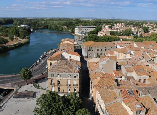 an aerial view of a town next to a river at Évasion Balnéaire au Cap d'Agde in Cap d'Agde