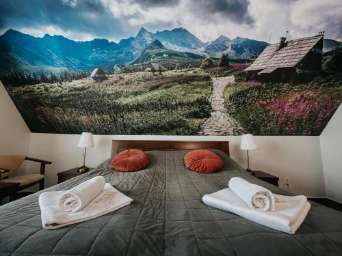 a bedroom with a large painting on the wall at Willa Pachówka - tam, gdzie natura spotyka się z nowoczesnością in Bukowina Tatrzańska