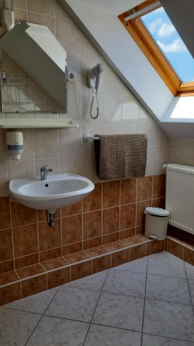 a bathroom with a sink and a skylight at Villa Nova in Hévíz