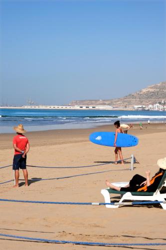 a group of people on the beach with surfboards at Valeria Jardins d'Agadir - All In in Agadir