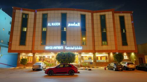 a car parked in a parking lot in front of a building at Al Masem Serviced Apartments - Gharnata - Exit 9 in Riyadh
