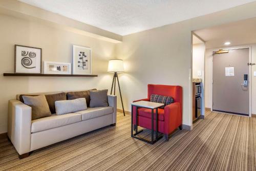 a living room with a couch and a chair at Country Inn & Suites by Radisson, Atlanta Galleria-Ballpark, GA in Atlanta