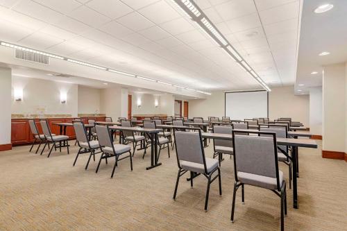 a conference room with tables and chairs and a whiteboard at Country Inn & Suites by Radisson, Atlanta Galleria-Ballpark, GA in Atlanta