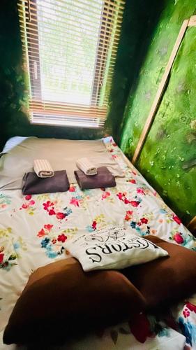 a bed with two pillows on it in a room at Lazy Deer - Camp in Staniszów