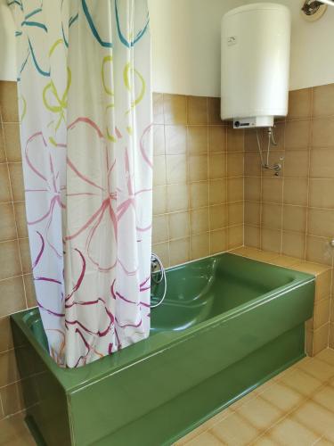a bath tub in a bathroom with a shower curtain at Apartment Kira - spacious apartment with sea view in Ližnjan