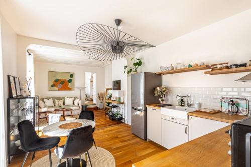 une cuisine et un salon avec une table et des chaises dans l'établissement GuestReady - Apt de charme dans le centre de Paris IX, à Paris